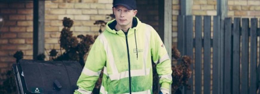 Medarbejder tømmer skraldecontainer